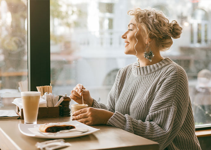 woman in a coffee shop looking out a window